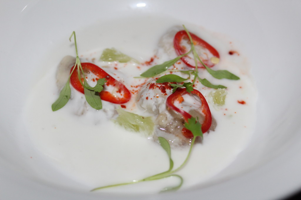 Oyster Kinilaw with lime, ginger, fresno chilis, coconut milk, and micro cilantro